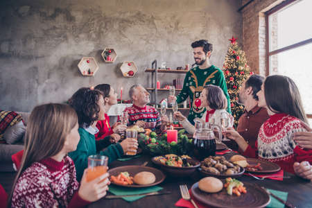 Photo of small preteen school wife husband retired pensioner people toast xmas dinner table indoors inside homeの写真素材