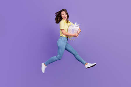 Full size profile photo of funky millennial brunette lady run hold gift wear top jeans shoes...