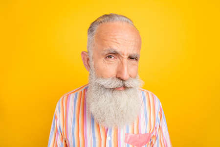 Photo of suspicious attentive mature man dressed yellow shirt looking you isolated yellow color...