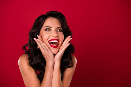 Portrait of attractive cheerful amazed wavy-haired nude girl having fun good great news isolated over bright red color backgroundの写真素材
