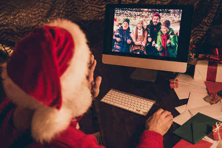 Photo of aged santa claus happy positive smile speak video call computer conversation family...