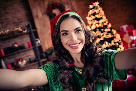 Photo of cool young brunette lady do selfie wear green costume at home on holidayの写真素材