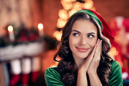 Photo of nice young brunette lady hold hands look wear green costume at home on holiday