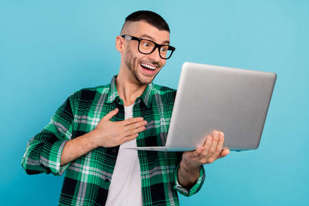 Photo of amazed cheerful positive man online meeting smile good mood enjoy isolated on blue color backgroundの写真素材