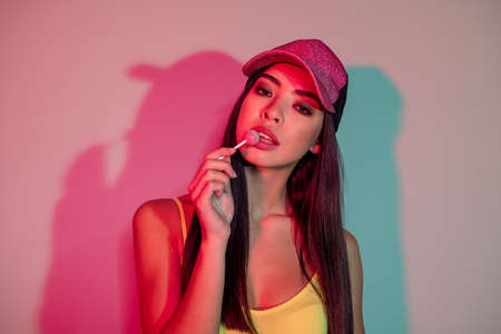 Portrait of attractive cool alluring girl eating lollipop rest free time summer isolated over shine...