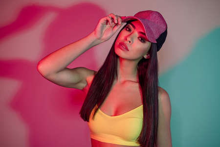 Photo of hipster young brunette dj lady wear cap yellow top isolated on neon purple color background