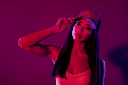 Portrait of attractive gorgeous girl posing touching hat isolated over shine purple violet color backgroundの写真素材