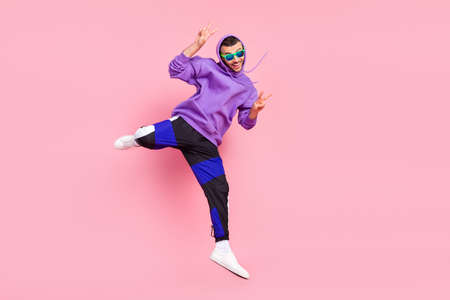 Full body photo of funny young brunet guy jump wear eyewear hoodie pants shoes isolated on pink backgroundの写真素材