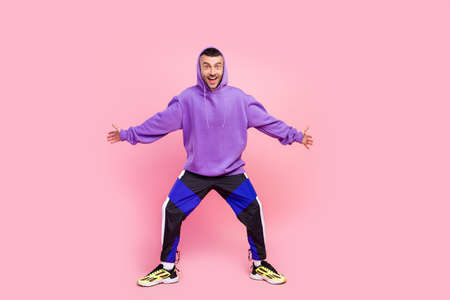 Full body photo of young excited guy surprised unexpected sportive outfit isolated over pink color backgroundの写真素材