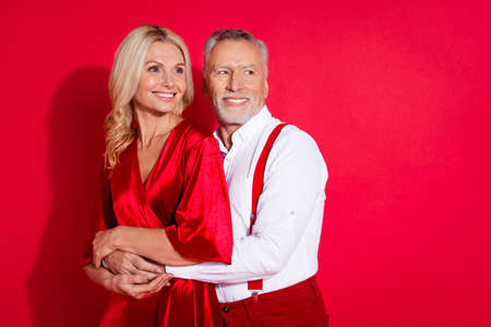 Profile side photo of retired boyfriend girlfriend dream romantic date cuddle look empty space isolated over red color backgroundの写真素材