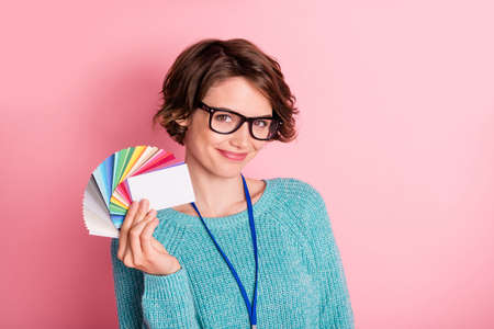 Photo of happy nice young woman hold color palette designer isolated on pastel pink color background
