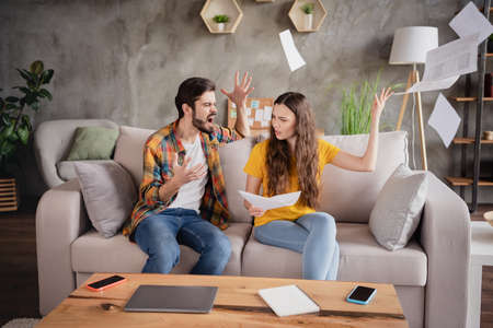 Photo of annoyed angry young couple wear casual outfits busy working shouting throwing papers...