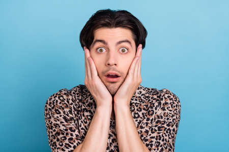 Portrait of attractive amazed worried guy stupor sudden news reaction isolated over bright blue...