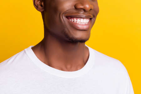 Cropped photo of smile brunet young guy wear white t-shirt isolated on yellow color background