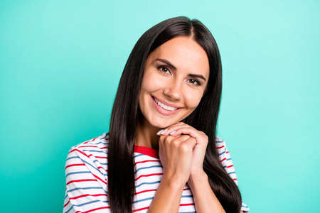 Photo of cute adorable lady beaming white smile hands chin wear striped t-shirt isolated teal color backgroundの写真素材