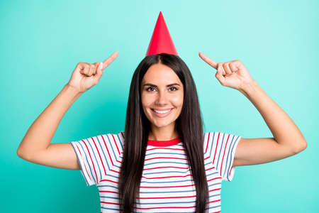 Photo of charming cheerful lady indicate fingers hat beaming smile look camera isolated on teal...