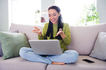 Full body photo of young happy woman sit sofa talk camera laptop inside house home indoors