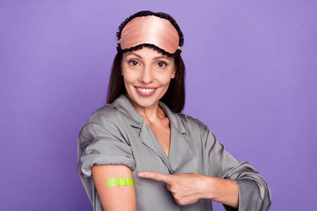 Portrait of beautiful trendy cheerful woman showing plaster on shoulder stop mers cov isolated over...