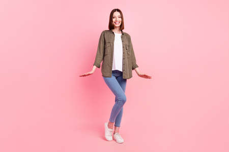 Full length photo of funny brunette hairdo lady stand wear green shirt jeans sneakers isolated on...
