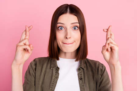 Photo of nervous bob hairdo millennial lady crossed fingers wear jeans shirt isolated on pink color...