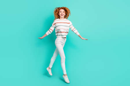 Full length body size photo curly woman smiling jumping up laughing in casual clothes isolated...