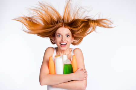 Photo of young excited girl happy positive smile hug cuddle bottle shampoo isolated over grey color...