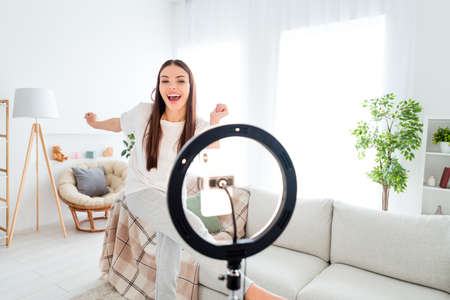 Photo of carefree funny blogger lady dance tripod phone video live broadcast wear white t-shirt...