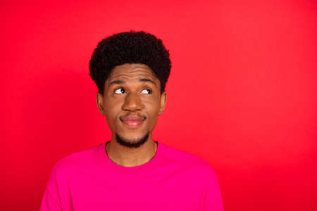 Portrait of attractive cheery minded brunet guy creating solution isolated over bright red color...