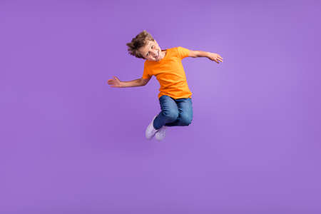 Full length body size photo boy jumping careless cheerful happy isolated pastel violet color...