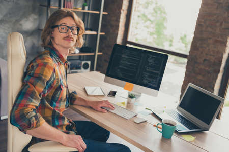 Profile side photo of young man happy positive smile coding html jawa script technology laptop pc sit desk office indoorsの写真素材
