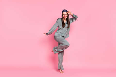 Photo of pretty sweet young lady sleepwear dancing smiling isolated pastel pink color background