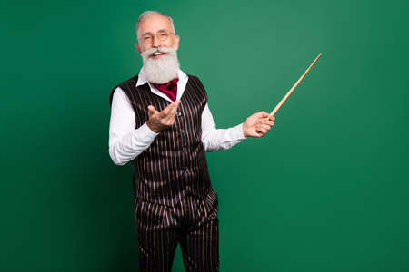 Photo of charismatic professor teach lesson pointer show blank space wear specs striped suit scarf on green color backgroundの写真素材