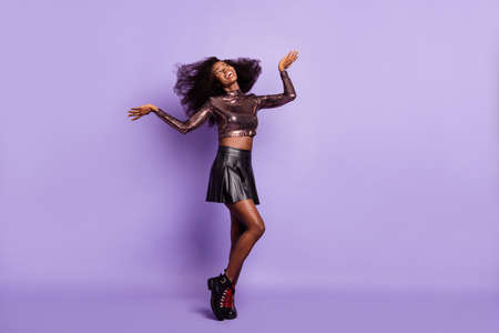 Photo of dreamy cute lady dance have fun wear glossy shirt short skirt footwear isolated purple color backgroundの写真素材