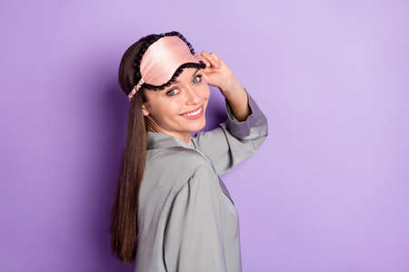 Profile side view portrait of attractive cheerful girl wear pajama posing healthy life isolated over violet purple color backgroundの写真素材