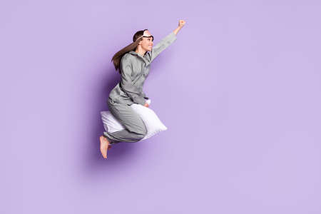 Full length body size photo of super woman riding on pillow flying high looking copyspace isolated...