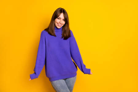 Portrait of gorgeous young person smile look camera wear purple pullover isolated on yellow color backgroundの写真素材