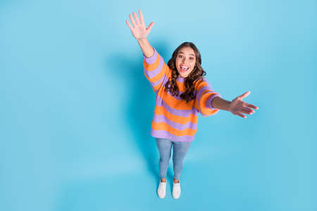 High angle view full body photo of astonished pretty person raise arms up open mouth isolated on...