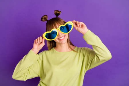 Photo of cute pretty young woman dressed green pullover arm dark heart glasses isolated purple color...