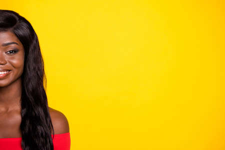 Cropped photo of adorable shiny half dark skin girl dressed red top empty space isolated yellow color backgroundの写真素材