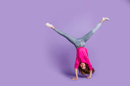Full size photo of young happy cheerful good mood positive girl hand standing isolated on violet color backgroundの写真素材