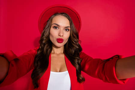 Photo of flirty sweet young woman wear suit jacket cap recording self video sending kiss isolated...