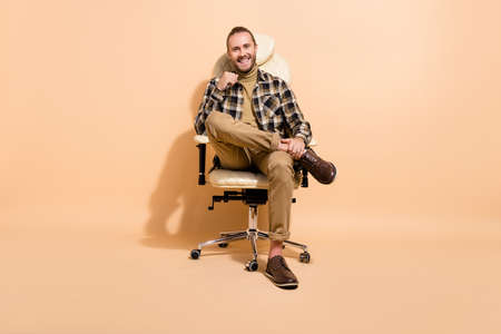 Full length photo of young cheerful guy enjoy break after negotiation boss isolated over beige color...