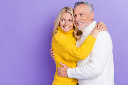 Photo of funny sweet senior husband wife dressed knitwear sweaters hugging looking empty space...