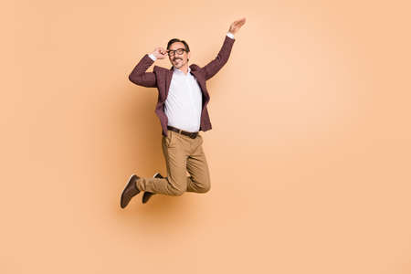 Full length body size view of attractive cheerful carefree man jumping showing copy space offer...