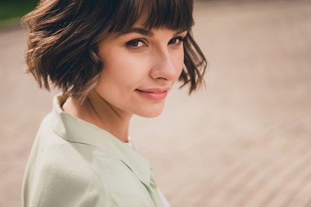 Photo of sweet adorable young lady dressed green shirt walking smiling outdoors urban park