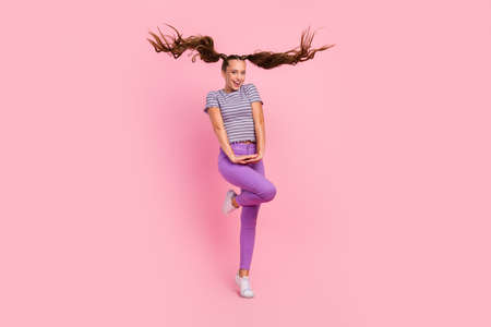 Photo of girlish pretty young lady wear striped t-shirt smiling dancing isolated pink color...