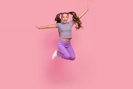 Full length body size view of attractive cheerful childish girl jumping having fun fooling isolated...