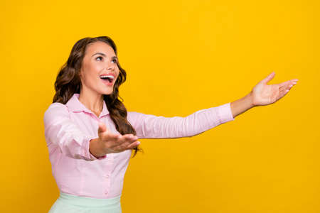 Photo of hooray millennial brunette lady hug empty space wear pink shirt isolated on yellow color backgroundの写真素材