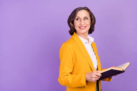 Profile photo of nice professor grey elder lady read book look empty space wear eyewear yellow...