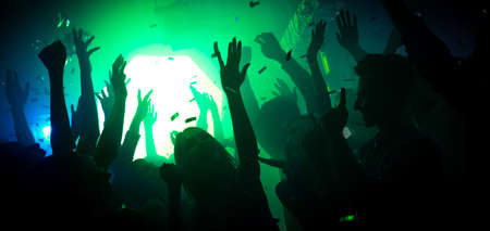 Photo of carefree audience ladies guys clubbers raise hands up on show corporate festival have green...